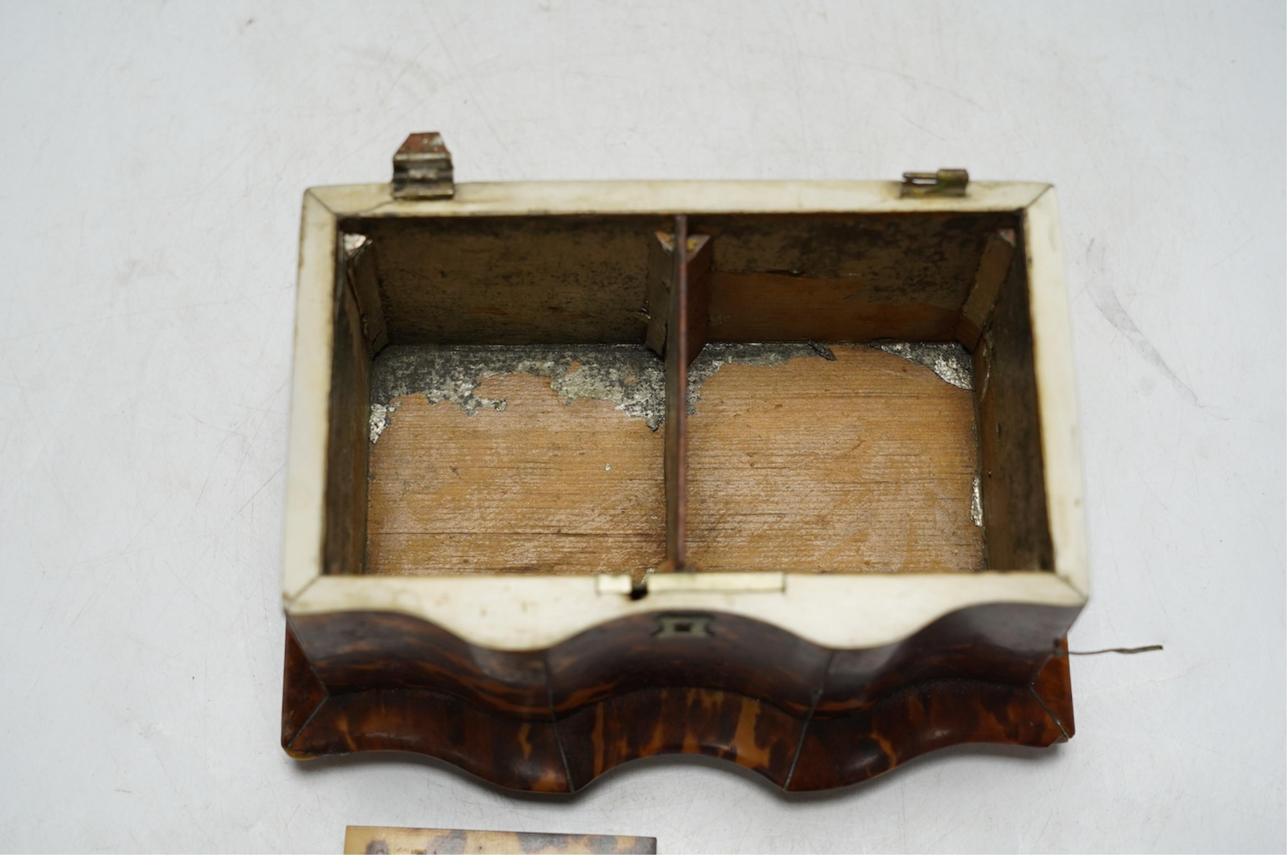 A Regency tortoiseshell tea caddy with inlaid silver and ivory stringing, on later bun feet, 12cm high. CITES Submission reference 64HKMP8J. Condition - poor to fair, lid detached, some repairs needed to stringing